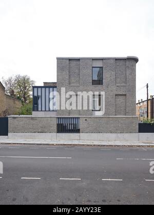 Front elevation of building across street. Corner House, London, United Kingdom. Architect: 31/44 Architects, 2019. Stock Photo