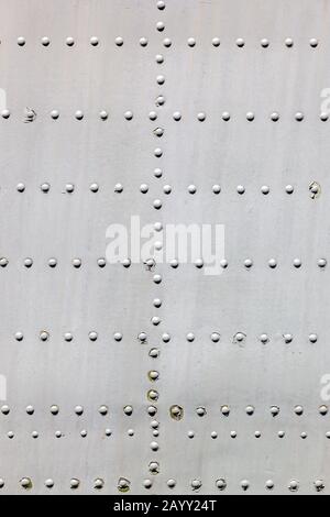 Grey metal surface with rivets as background Stock Photo