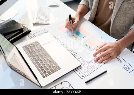 Unrecognizable professional software designer working on new application sketch, horizontal high angle shot Stock Photo