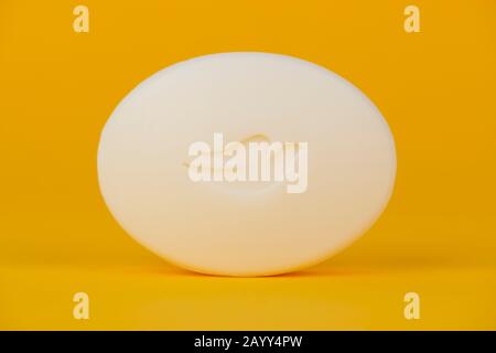 A bar of Dove Soap shot on a yellow background. Stock Photo