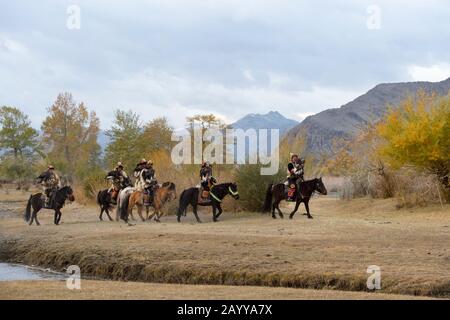A group of Kazakh Eagle hunters and their Golden eagles on horseback at our ger camp next to the Hovd River near the city of Ulgii (Ölgii) in the Baya Stock Photo