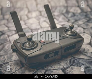 Modern remote control drone or copter on the background of stones Stock Photo