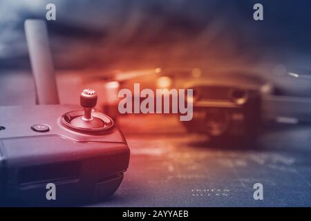 Remote controller and blurred copter in the background with red light Stock Photo