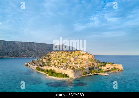 Aerial view of the island of Spinalonga with calm sea. Here were isolated lepers, humans with the Hansen's desease, gulf of Elounda, Crete, Greece. Stock Photo