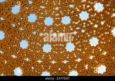 Roof design of dome, gold in colour with cut out stars and other geometric shapes. Would make a beautiful background. Muscat, Oman. Stock Photo