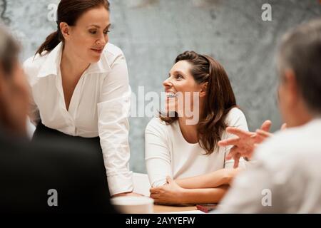Group of architects brainstorming around a conference table. Stock Photo