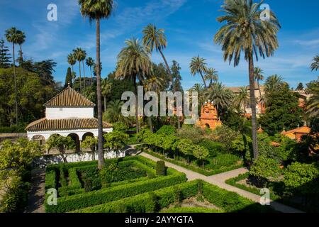 View of the gardens from the Galeria de Grutescos in the Alcazar, a royal palace, originally a Moorish fort in Seville, Andalusia, Spain. Stock Photo