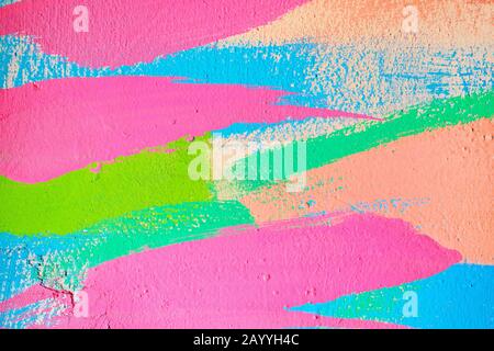 Abstract texture of plaster from wavy lines from a brush of pink, blue, green and beige color. Close up. Stock Photo