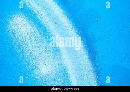 Abstract metal texture painted with a brush of blue and white. Close up. Stock Photo
