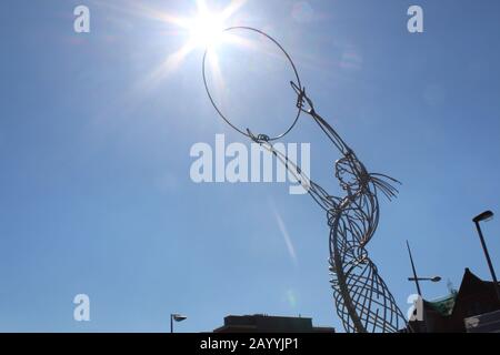 Sun shine on the Beacon of hope (sculpture) at Queen Elizabeth Bridge, Belfast, NI Stock Photo