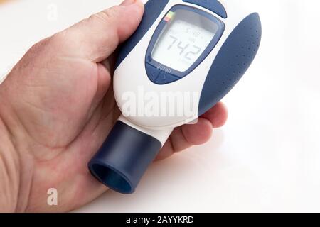 man holding a spirometer for home testing. Stock Photo