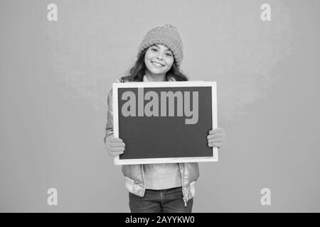 Open hours. Winter entertainment and activities. Happy hours. Promotion concept. Smiling girl wear winter outfit show blank chalkboard copy space. Fresh information. Schedule and working hours. Stock Photo