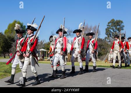 British redcoat soldiers marching during a reenactment of the American revolution  in 'Huntington central  park' Huntington Beach California USA Stock Photo