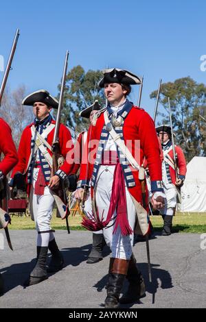 British redcoat soldiers marching during a reenactment of the American revolution  in 'Huntington central  park' Huntington Beach California USA Stock Photo