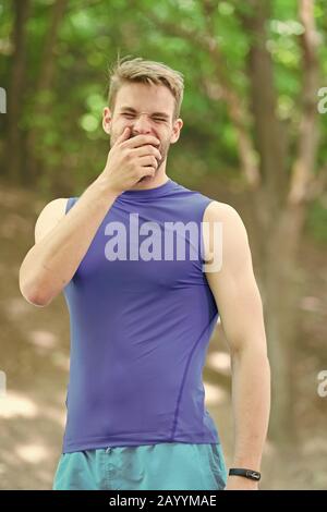 Feeling tired. Daily walk for healthy life. Muscular strong fit guy sport coach. Handsome sportsman in sportswear outdoors. Active sportsman training outdoor. Sportsman living healthy lifestyle. Stock Photo