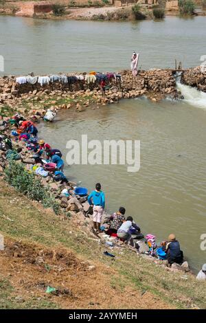 People washing laundry in river on the outskirts of Antananarivo, the capital city of Madagascar. Stock Photo