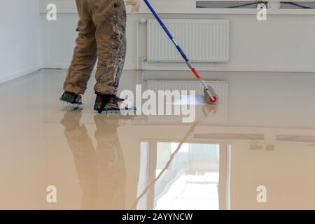 LAREN, THE NETHERLANDS - MAY 16, 2012: Synthetic cast resin floor installation indoors. Stock Photo