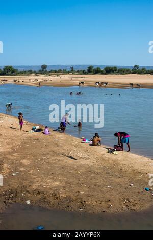 People washing and bathing at the Mandrare River near Berenty in southern Madagascar. Stock Photo