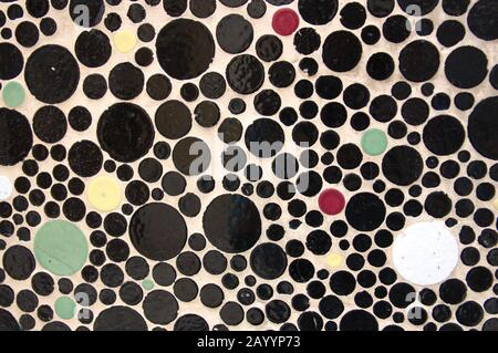 Circles of different colors and sizes are part of an abstract texture in the decoration of a wall Stock Photo