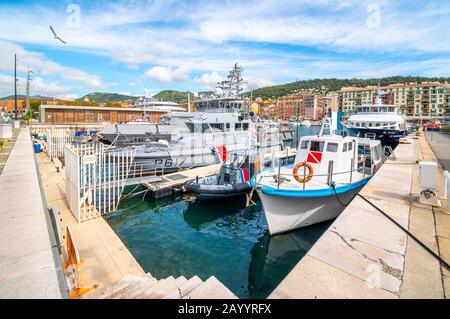 An assortment of boats and watercraft in the old harbor of Port Lympia in the city of Nice France, on the Mediterranean Sea at the French Riviera.