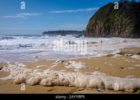 sea foam, ocean foam, beach foam or spume on Jones Beach, Kiama, NSW Australia after high winds and rough seas following severe stormy weather Stock Photo