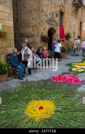 People waiting for the procession in street decorated with flowers for the Corpus Christi holiday, a catholic observance that honors the Holy Eucharis Stock Photo