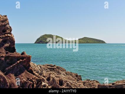 Double Island offshore from the rocky headland at the top end of Palm Cove Beach in tropical Cairns well up the coast in northern Queensland Australia Stock Photo