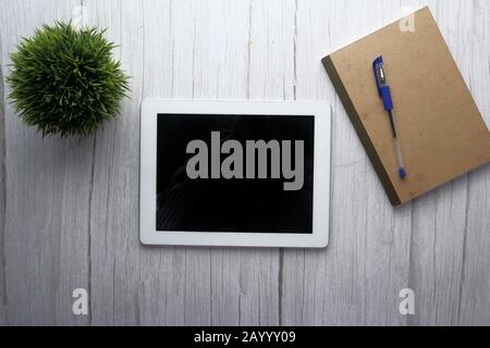 top view of digital tablet, notepad and pen on table  Stock Photo