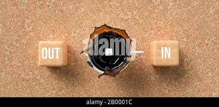 cup of coffee and cubes with the words OUT and IN on cork background - 3D rendered illustration Stock Photo
