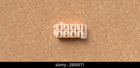 cubes with the words DON'T and DONE on cork background - 3D rendered illustration Stock Photo