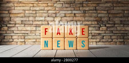 cubes with the words FAKE NEWS in front of a brick wall - 3D rendered illustration Stock Photo