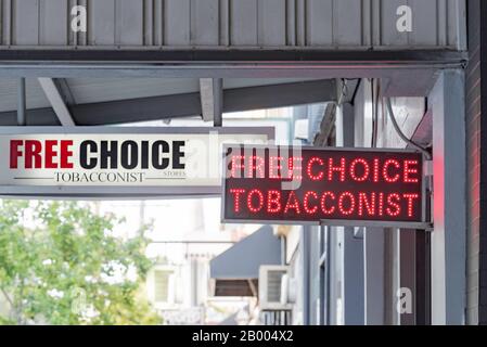 Signs hanging outside a Free Choice Tobacconist shop of tobacco store in  the Melbourne suburb of Fitzroy, Australia Stock Photo