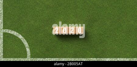 number 2020 on cubes lying on green grass background - 3D rendered illustration Stock Photo