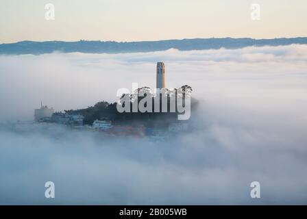 Coit Tower Surrounded by Early Morning Fog in San Francisco Stock Photo