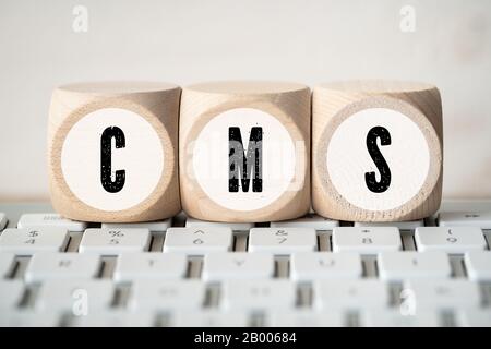 acronym CMS on cubes on a computer keyboard Stock Photo