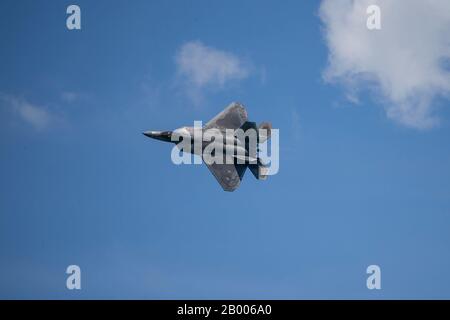 A U.S. Airforce F-22 Raptor with the 154th Wing, Hawaii Air National Guard, conducts an aerial demonstration during the Singapore Airshow 2020 near Changi Exhibition Center, Republic of Singapore, Feb. 15, 2020. Singapore Airshow 2020 showcased various U.S. military aircraft and featured the F-22 Raptor and the F-35B Lightning II aerial demo teams. This was the first time both stealth fighter attack jets participated in the aerial demonstration, giving spectators an unprecedented look at the advanced fifth generation fighters. (U.S. Marine Corps photo by Staff Sgt. Vitaliy Rusavskiy) Stock Photo