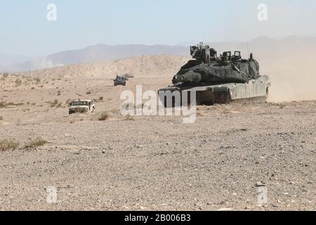 U.S. Army Soldiers assigned to 5th Squadron, 7th Calvary Regiment, 1st Armored Brigade Combat Team, 3rd Infantry Division, Fort Stewart Ga., move to their objective inside a convoy of M1A2 Abrams Main Battle Tanks during Decisive Action Rotation 20-04 at the National Training Center (NTC), Fort Irwin, Calif., Feb. 14, 2020. Decisive Action Rotations at the NTC ensure Army Brigade Combat Teams remain versatile, responsive, and consistently available for current and future contingencies. (U.S. Army photo by Sgt. Nathan Franco, Operations Group, National Training Center) Stock Photo