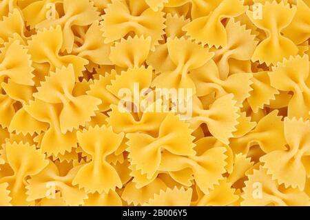 Farfalle pasta background also know as bow tie pasta and butterfly pasta Stock Photo