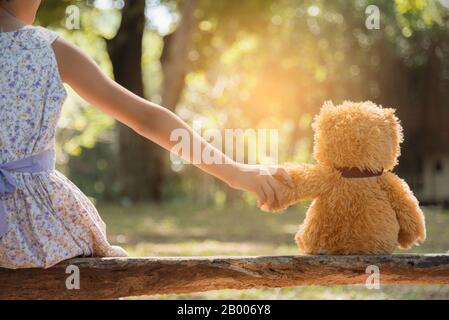 teddy bear is a best friend for all little cute girl. Child autism can be more happy and fun when they're play in family. Feel love and care. Family F Stock Photo