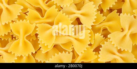 Farfalle pasta background also know as bow tie pasta and butterfly pasta Stock Photo