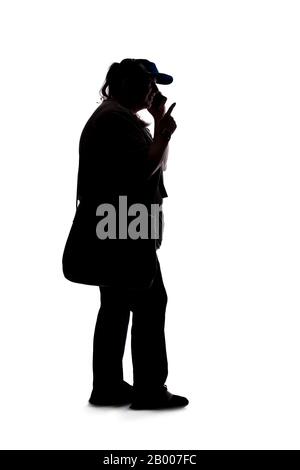Silhouette of a curvy or plus size woman on a white background.  She is unrecognizable and using a cell phone or smartphone Stock Photo