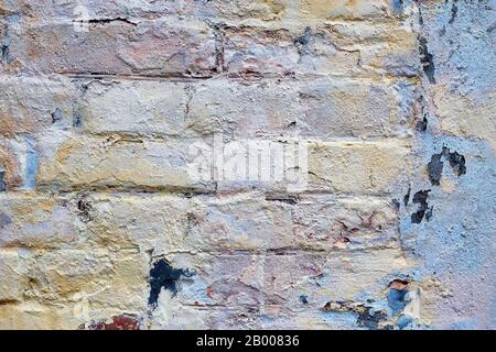 Loft damaged texture, wallpaper and background with painted red bricks and some color on it. Unusual design, decoration and exterior or interior detai Stock Photo