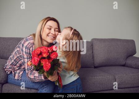 Happy mother's day. Daughter gives mom flowers. Stock Photo