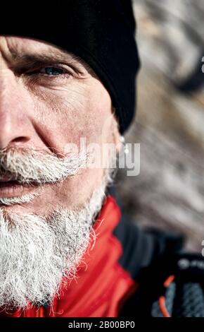 Emotional Portrait of serious elderly runner man with grey. Concept of power and c masculinity.