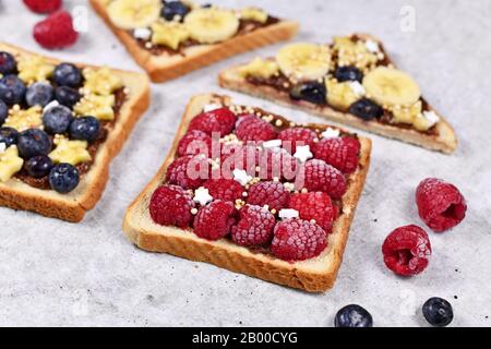 Healthy food with slice of spelt toast bread topped with red raspberry and puffed quinoa grains Stock Photo