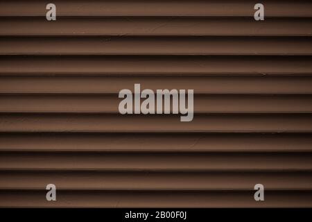 Metal striped pattern. Dark brown ribbed siding texture. Lines of fence, abstract grooved background Stock Photo
