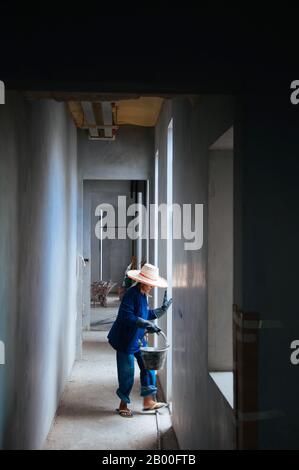 MAY 8, 2010 Bangkok, Thailand - Local Asian female construction labours working in building hallway Stock Photo