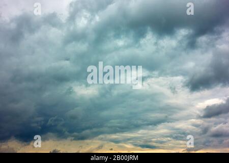Dramatic sky with gray heavy clouds, may be used as background Stock Photo
