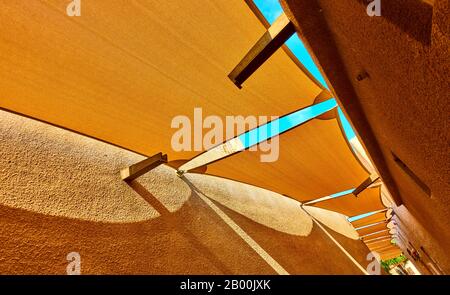 Perspective of traditional arabian street with fabric awnings in Al Fahidi Historical Neighbourhood in Old Dubai, United Arab Emirates (UAE). Wide ang Stock Photo