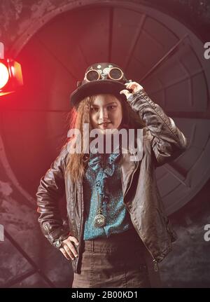 Beautiful steampunk teen girl  over vintage background , model in the style of a steampunk in a beautiful creative studio. Fashion, style Stock Photo